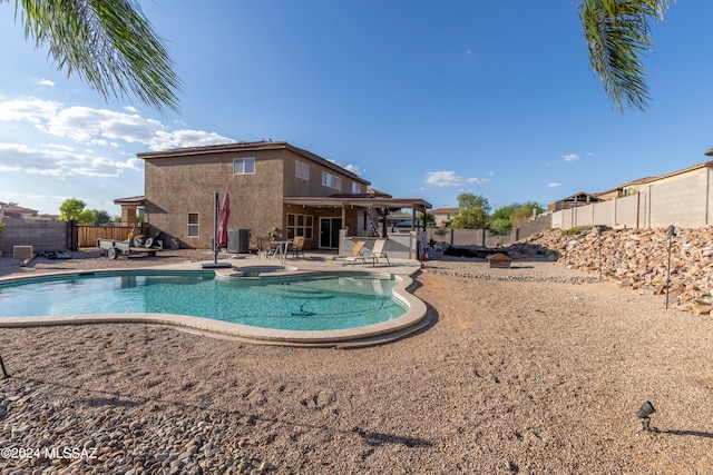 view of pool with a patio area and central air condition unit