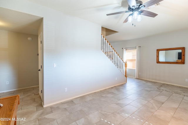 spare room featuring ceiling fan and light tile patterned flooring