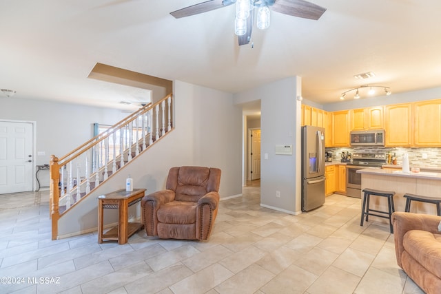 living room featuring light tile patterned floors and ceiling fan