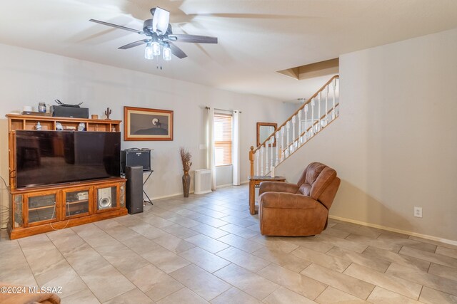 living room featuring ceiling fan and light tile patterned floors