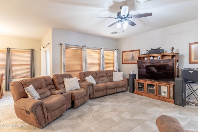 living room featuring plenty of natural light and ceiling fan