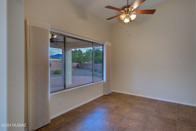 tiled empty room featuring ceiling fan