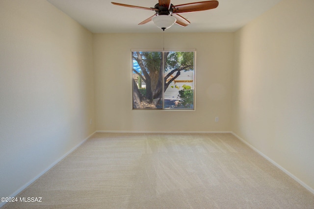 unfurnished room featuring light carpet and ceiling fan