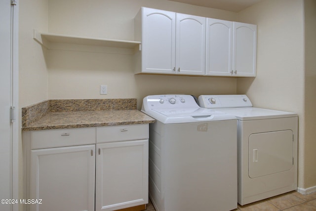 washroom featuring light tile patterned floors, cabinets, and independent washer and dryer