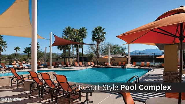 view of pool with a mountain view and a patio area