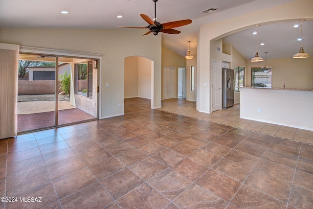 unfurnished living room with high vaulted ceiling, tile patterned floors, and ceiling fan