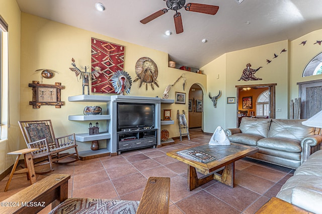 tiled living room with ceiling fan and vaulted ceiling