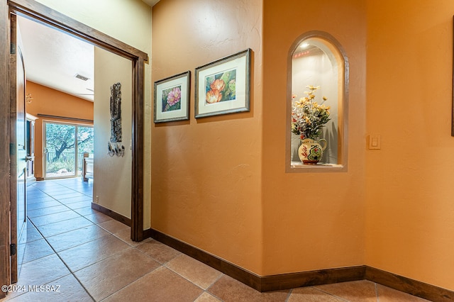 hall featuring light tile patterned floors