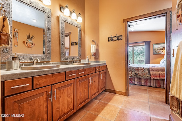 bathroom with lofted ceiling, vanity, ceiling fan, and tile patterned flooring