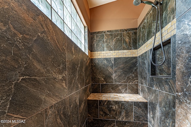 bathroom with tiled shower