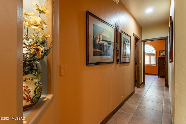 hallway with dark tile patterned floors