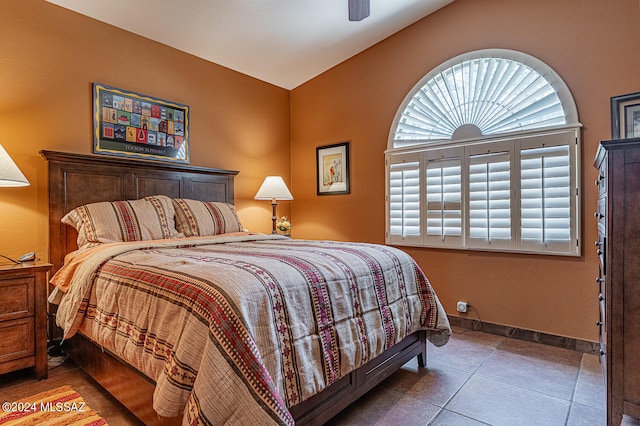 bedroom featuring lofted ceiling, ceiling fan, and tile patterned floors