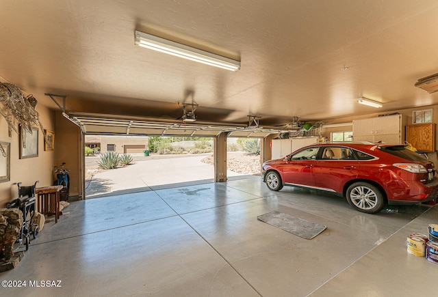 garage featuring a carport and ceiling fan