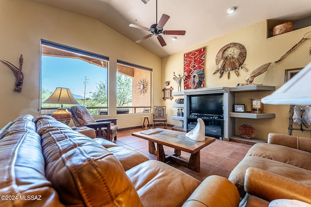 tiled living room with ceiling fan and vaulted ceiling