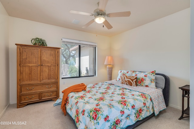 bedroom with ceiling fan and light colored carpet