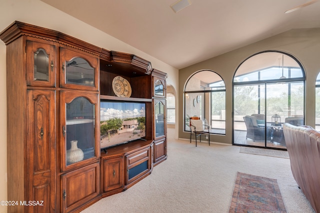 living room featuring light colored carpet and lofted ceiling