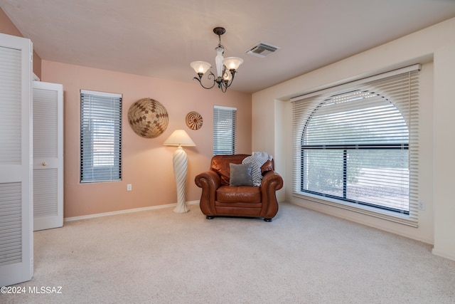 living area with a notable chandelier, light carpet, and plenty of natural light