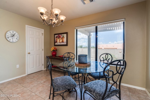 dining room with light tile patterned flooring and a chandelier