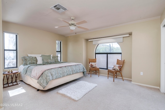 bedroom featuring ceiling fan, carpet, and multiple windows