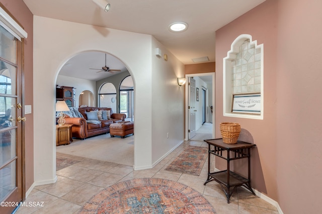 carpeted bedroom featuring connected bathroom and ceiling fan