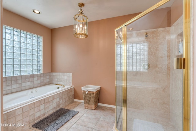 bathroom with plus walk in shower, tile patterned flooring, and a notable chandelier