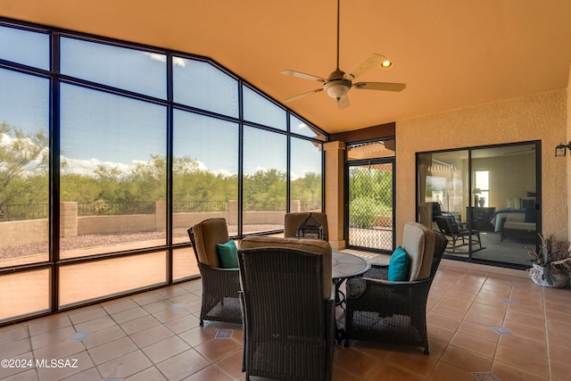 sunroom featuring lofted ceiling and ceiling fan