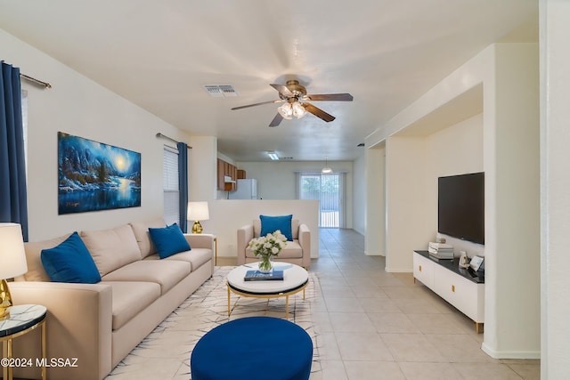 living room featuring ceiling fan and light tile patterned floors