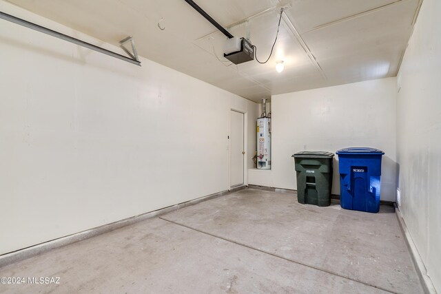 garage featuring a garage door opener and water heater