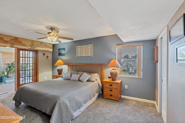 bedroom featuring multiple windows, access to outside, ceiling fan, and carpet flooring