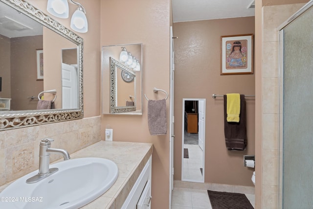 bathroom with tile patterned floors, vanity, and a shower stall