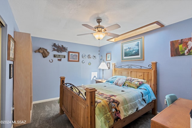 carpeted bedroom with a textured ceiling and ceiling fan