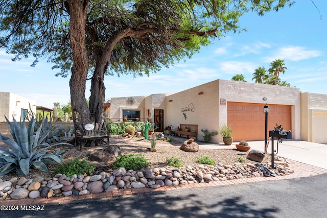 pueblo revival-style home with a garage