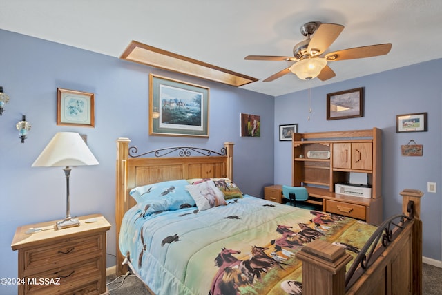 bedroom with ceiling fan and dark colored carpet