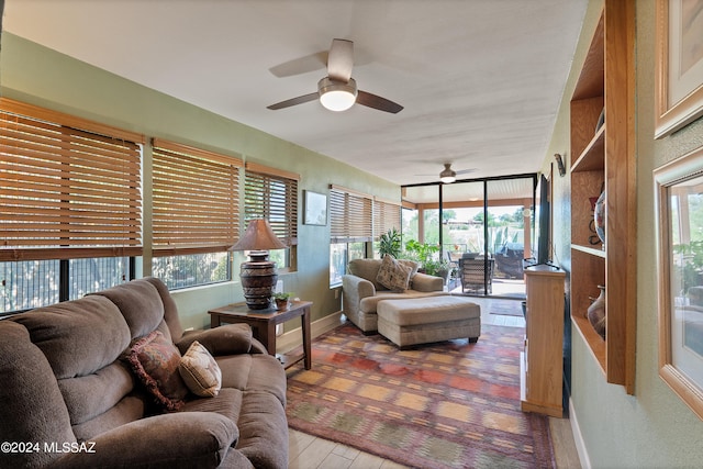 living room with a healthy amount of sunlight, ceiling fan, and hardwood / wood-style floors