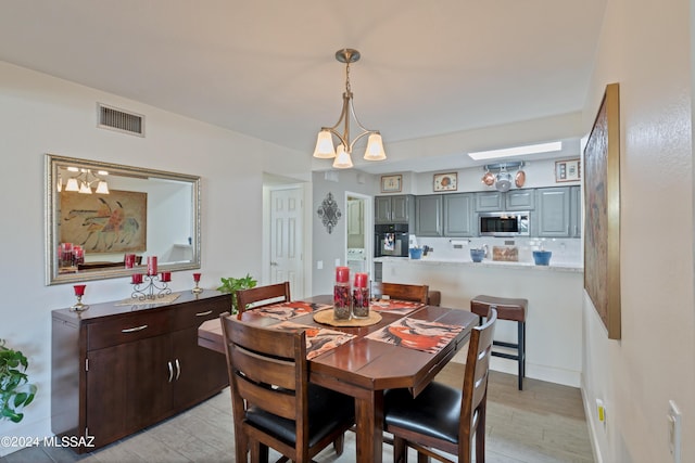 dining space with light wood finished floors and visible vents