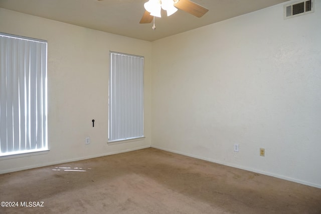 empty room featuring light colored carpet and ceiling fan