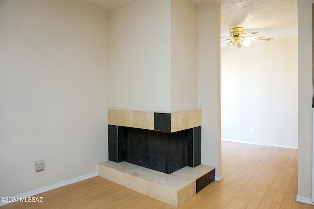 details featuring hardwood / wood-style floors, ceiling fan, and a multi sided fireplace