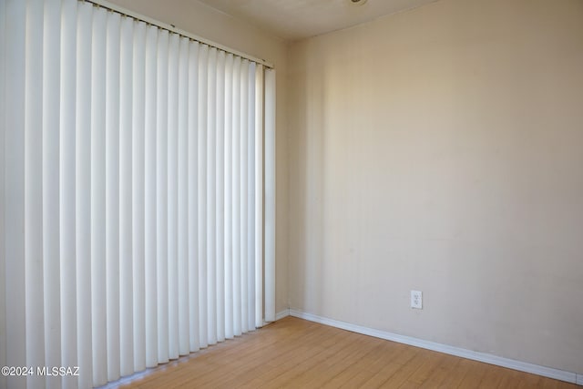 unfurnished room with light hardwood / wood-style flooring