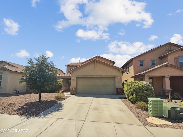 view of front of home featuring driveway, stucco siding, stone siding, a garage, and a tiled roof