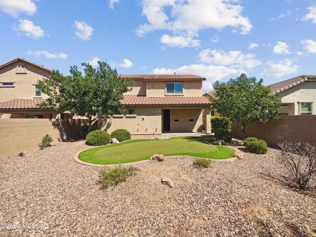 back of property featuring stucco siding, a patio area, a fenced backyard, and a tiled roof