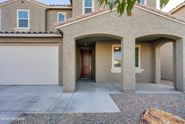 view of exterior entry with a garage