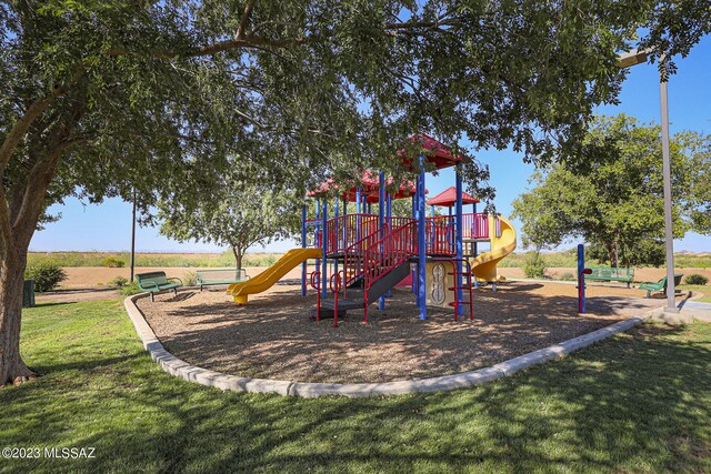 view of playground with a lawn