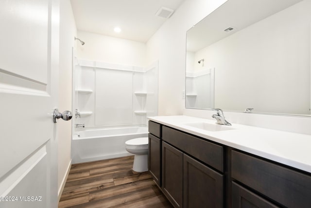 full bathroom with vanity, toilet, wood-type flooring, and bathing tub / shower combination