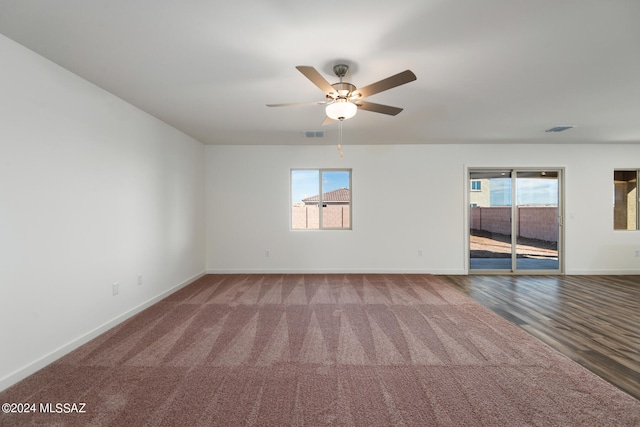 empty room featuring wood-type flooring and ceiling fan