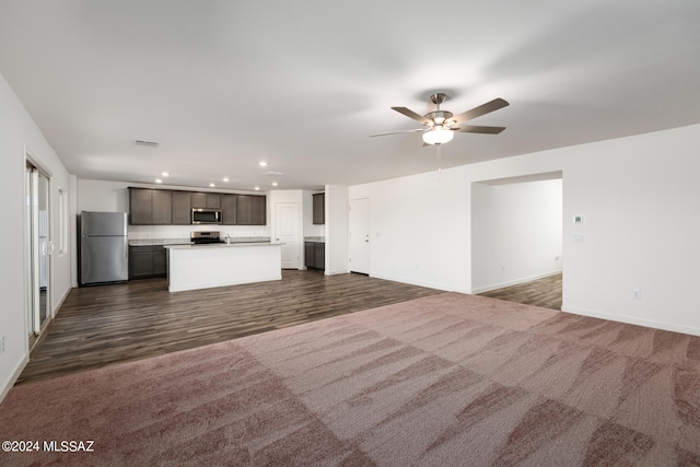 unfurnished living room with ceiling fan and dark hardwood / wood-style floors