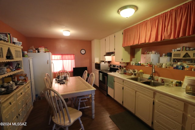 kitchen featuring white appliances, dark hardwood / wood-style flooring, white cabinetry, and sink