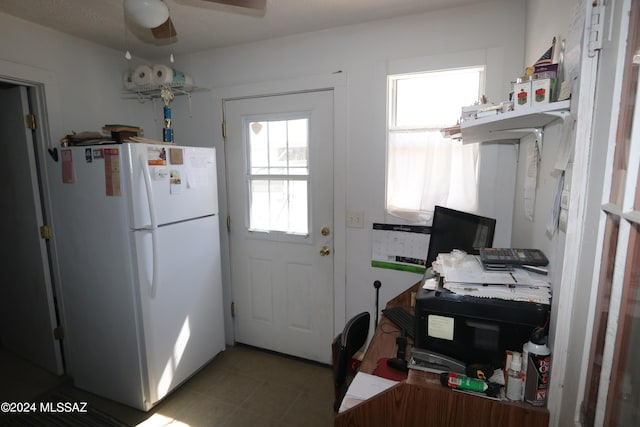 kitchen with white refrigerator, ceiling fan, and a wealth of natural light