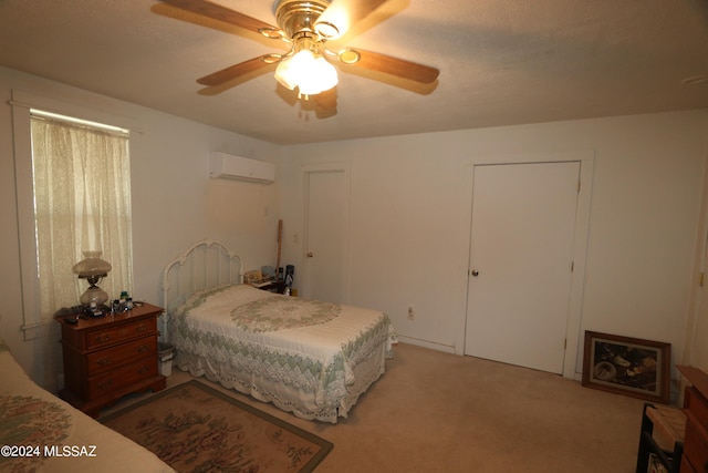 bedroom featuring a textured ceiling, a wall mounted AC, ceiling fan, and carpet