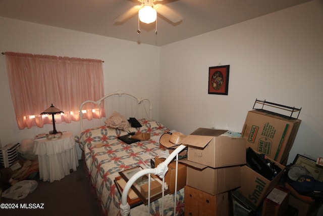 bedroom featuring dark colored carpet and ceiling fan