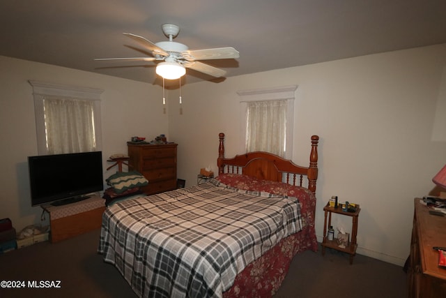 bedroom with dark carpet and ceiling fan